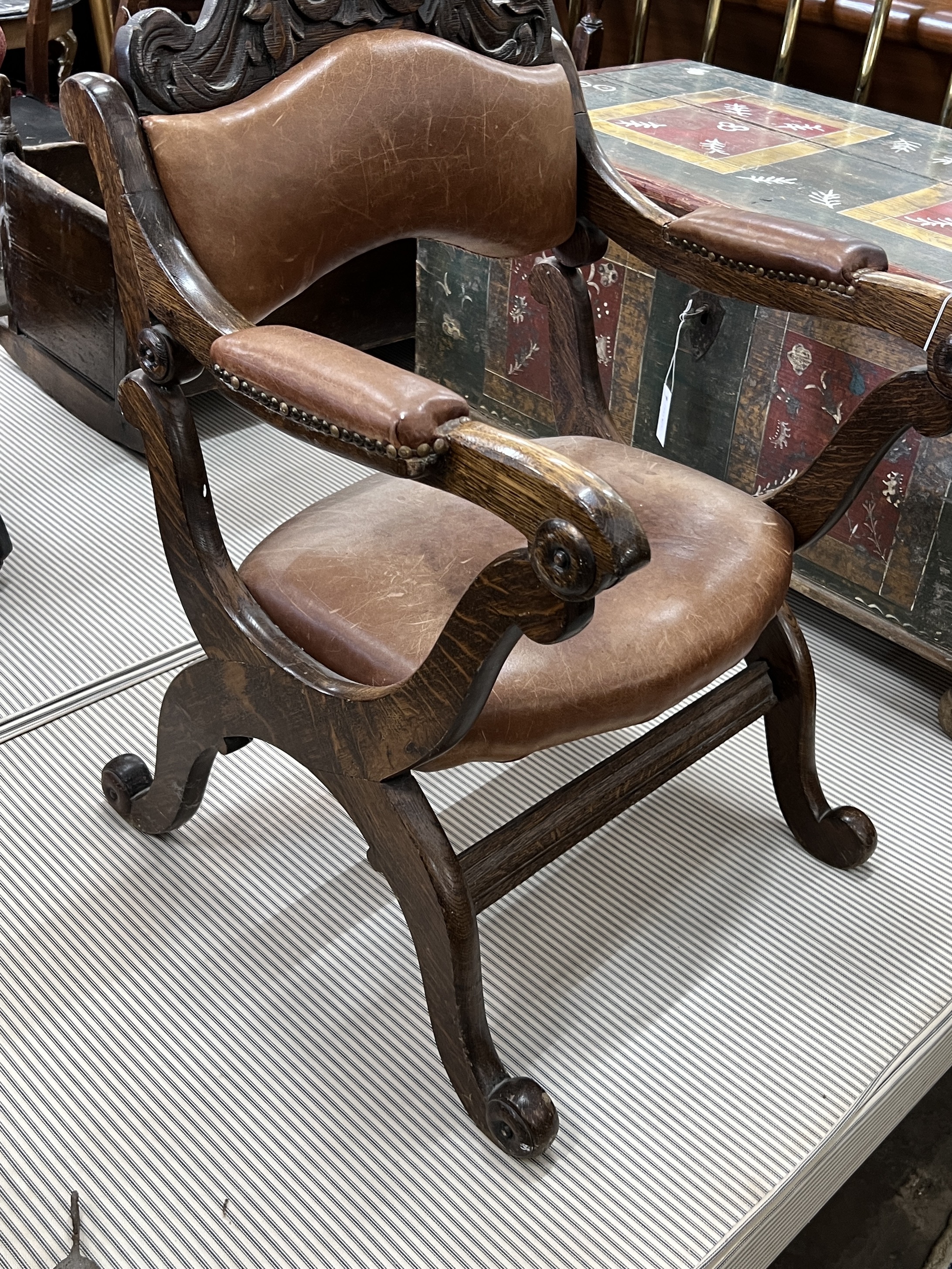 An early 20th century oak tan leather folding prayer chair, width 59cm, depth 62cm, height 90cm